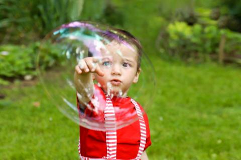 A child pointing at a big bubble