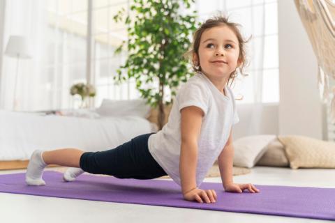 A young child doing a yoga pose