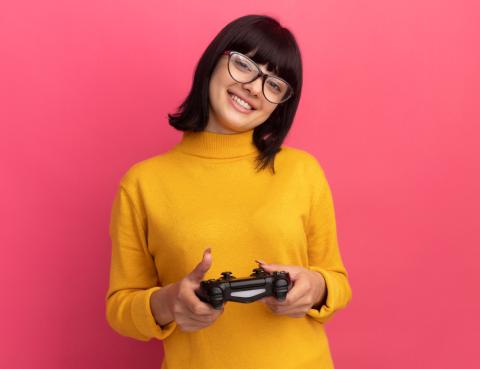 A female holding a gaming controller