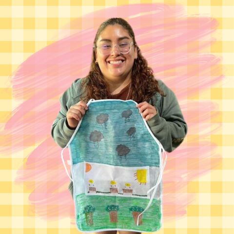 Young woman holding an apron she colored