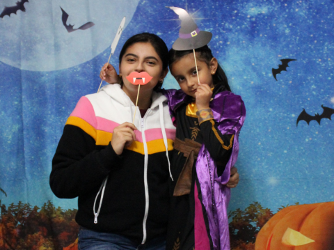 Two young ladies posing for a photograph