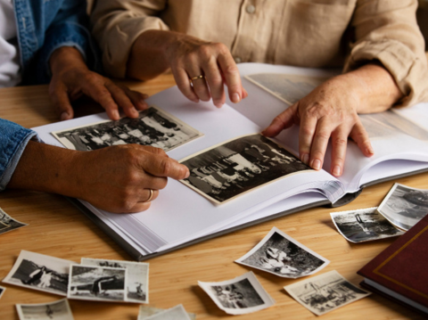 Two people looking at a photo album