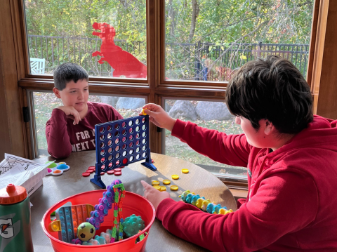 two teenage boys playing 4-in-a-row