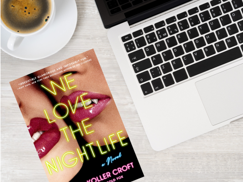 Book "We Love the Nightlife" by laptop and coffee