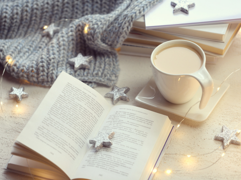 Open book, shining garland and silvery decorative stars on a light background